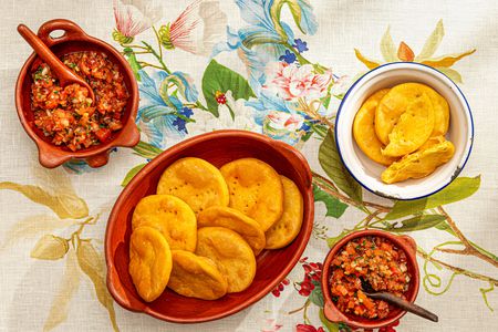 Overhead view of sopaipillas with pebre