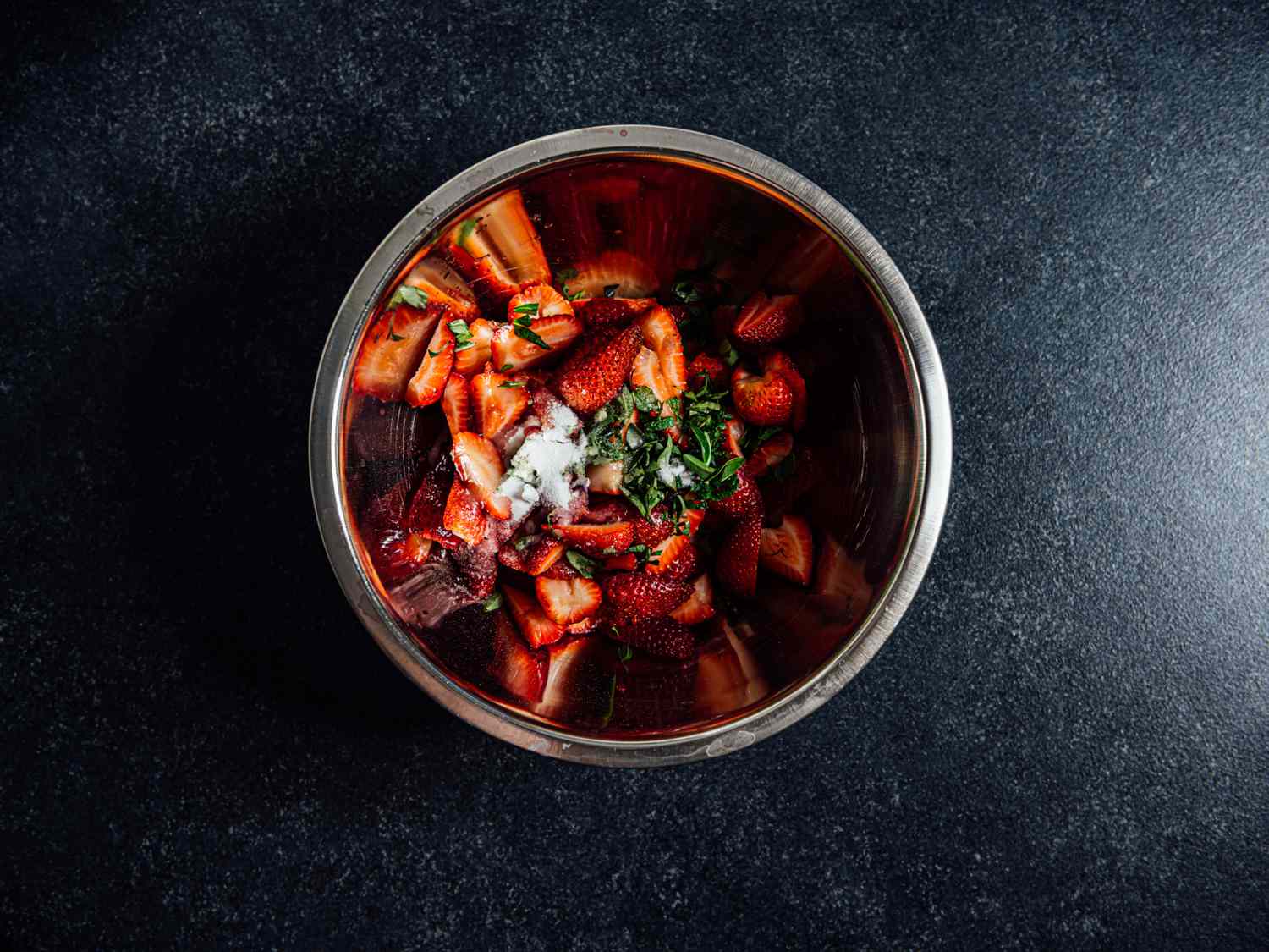 strawberries, mint, sugar, thai basil in a bowl