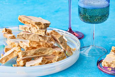 Side view of turron de alicante stacked on a plate