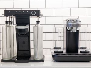 two cocktail machines side-by-side on a white surface