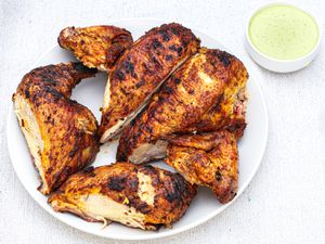 Peruvian-style grilled chicken with green sauce.