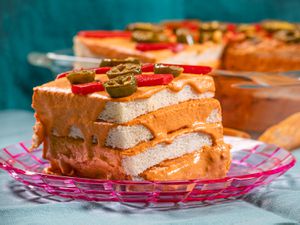 Side view of a piece of Pastel de Atun on a festive pink plate