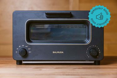 A Balmuda Toaster oven on a wooden countertop