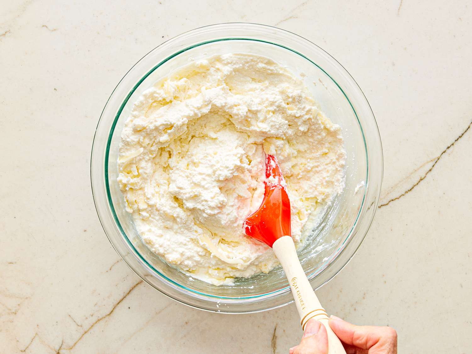 Overhead view of mixing cheese filling together