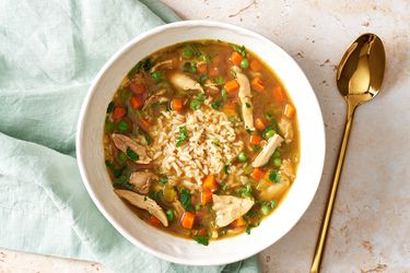 Chicken & rice soup in a white bowl.