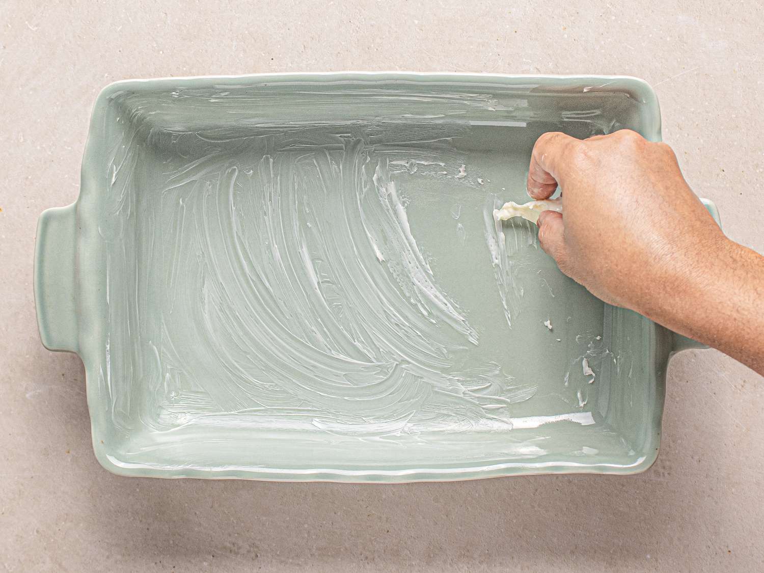 A large rectangular serving platter slathered in butter.