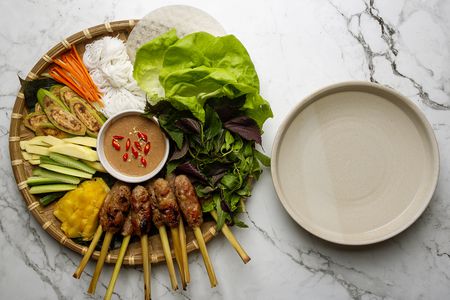 nem lui platter with a bowl of warm water alongside