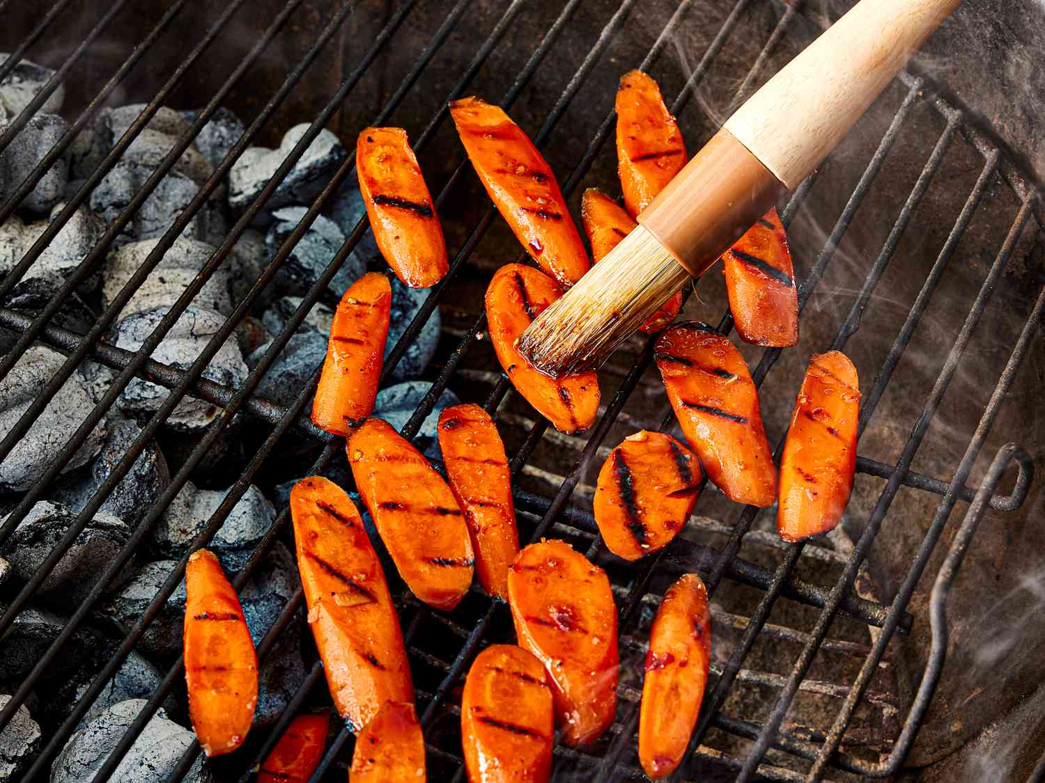 Overhead view of swiping glaze on carrots