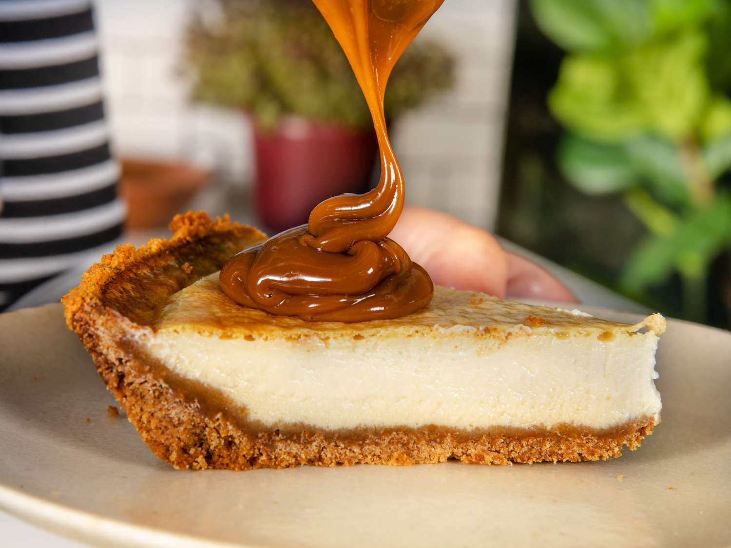 Slice of Pays de Queso being drizzled with dulce de leche