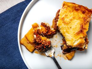 Overhead view of a fork of moussaka on a plate