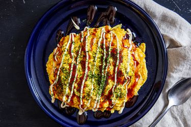 Overhead view of omurice on a blue palte