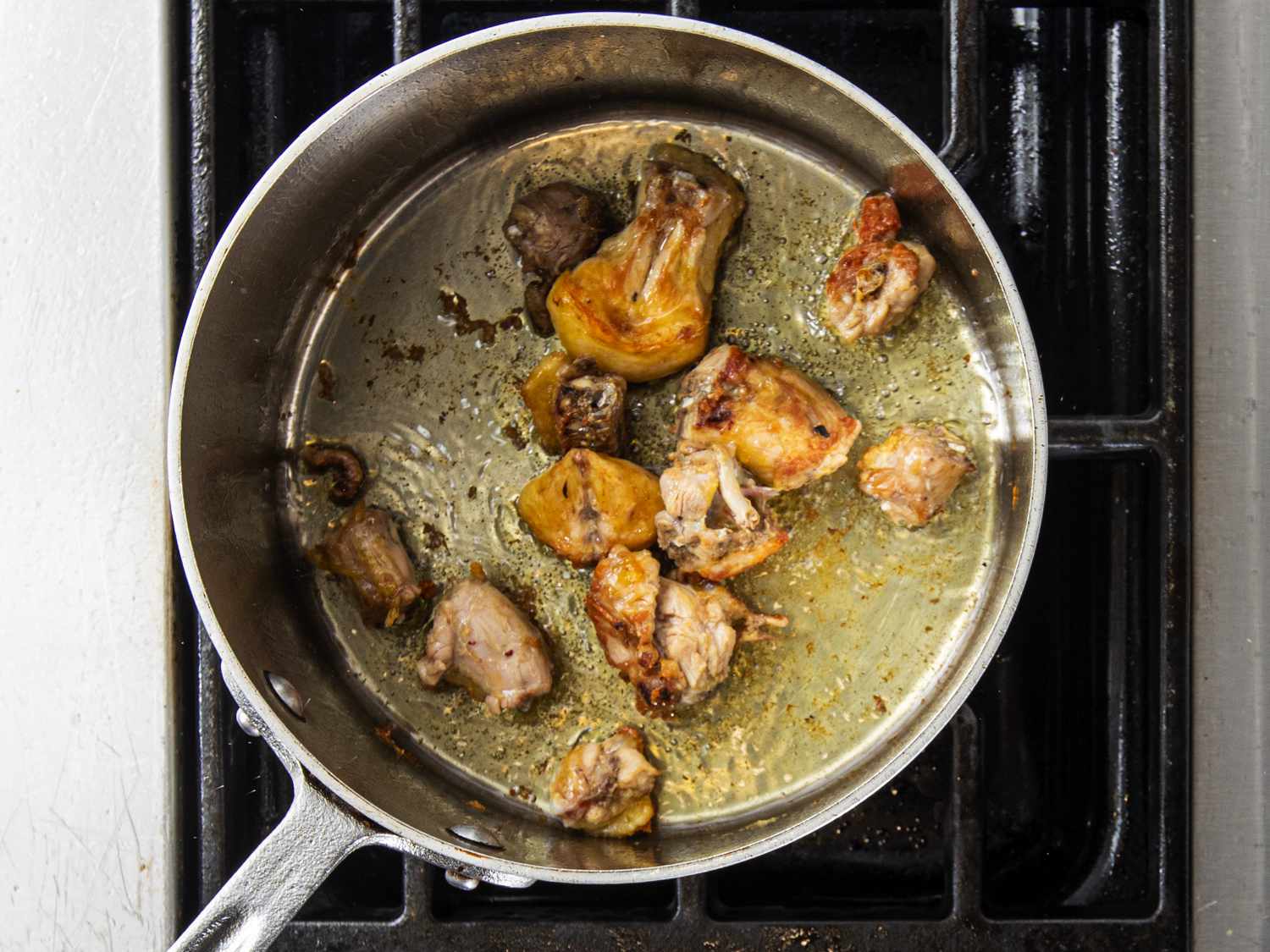 SautÃ©ing cut up pieces of a chicken back in pan to make jus