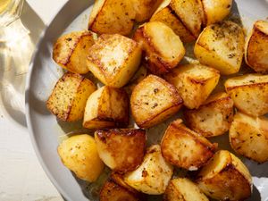 Closeup of a serving plate of Greek lemon potatoes.