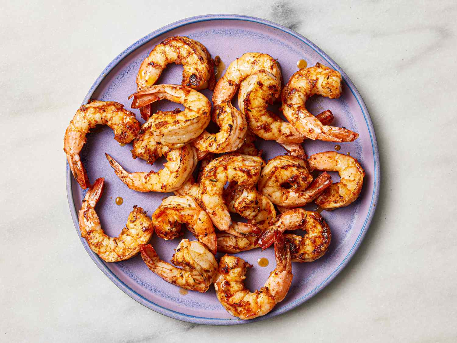 Cajun shrimp on a purple plate.