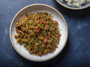 A plate of Khua Kling Gai on a blue table