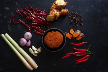 Prik Gaeng Pak Dtai (Southern Thai Curry Paste) with ingredients scattered around