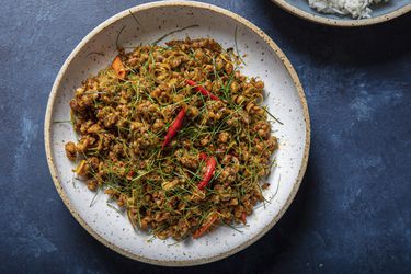 A plate of Khua Kling Gai on a blue table