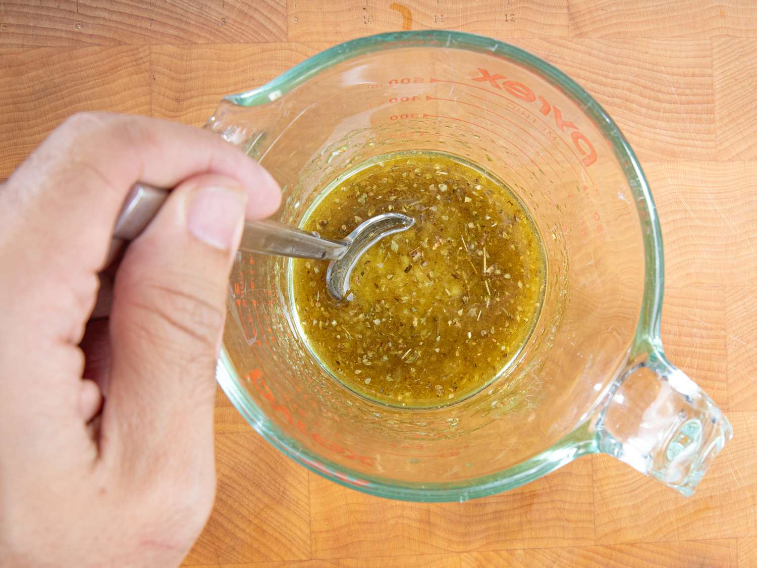 Overhead view of stirring marinade mix