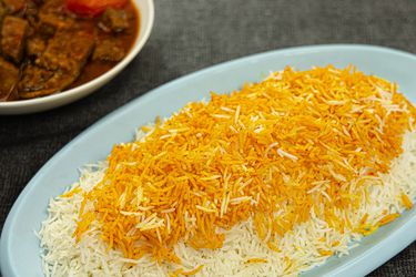 Overhead view of Persian rice on a blue paltter