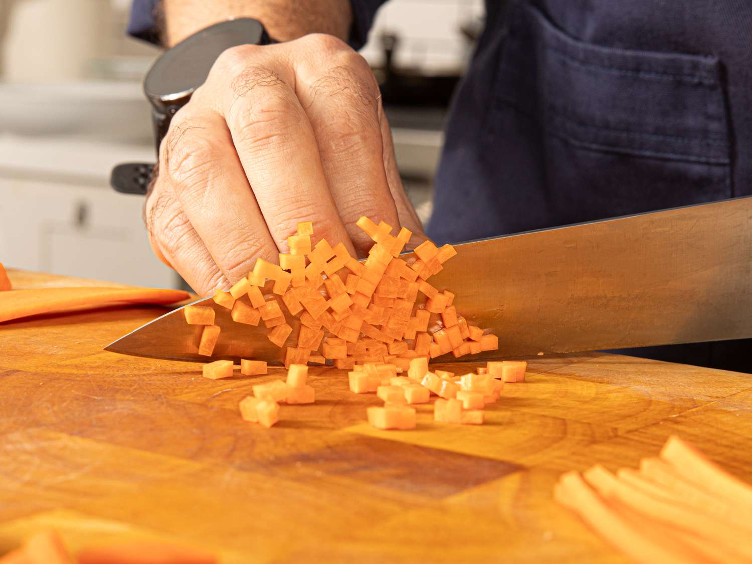 Side angle view of cutting carrots into bernoise