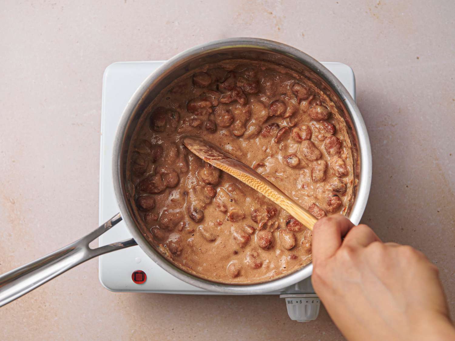 Fava beans, tahini, and garlic paste cooked inside medium saucepan