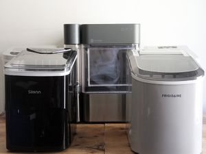 three winning ice makers on a wooden countertop with a white wall behind them.