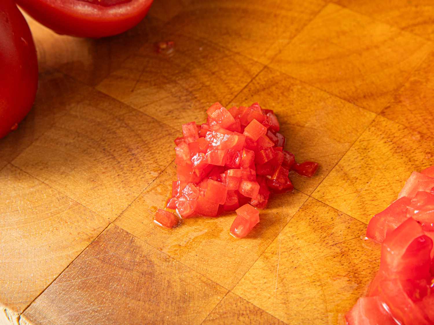 Finely diced tomatoes on a cutting board