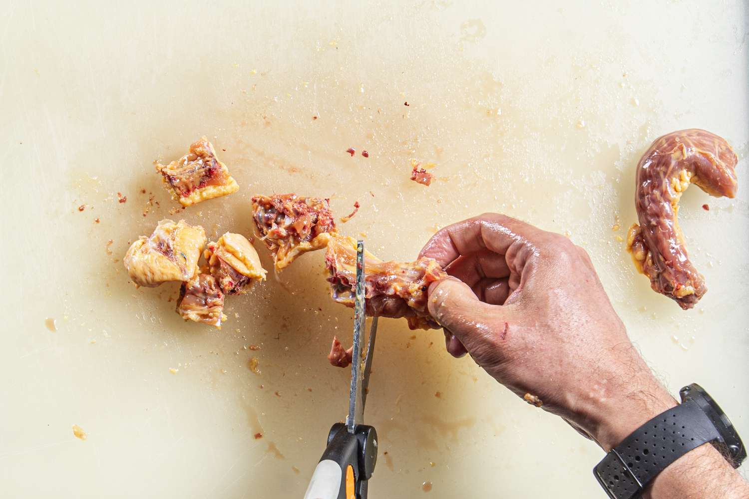 Overhead view of cutting the backbone with kitchen shears