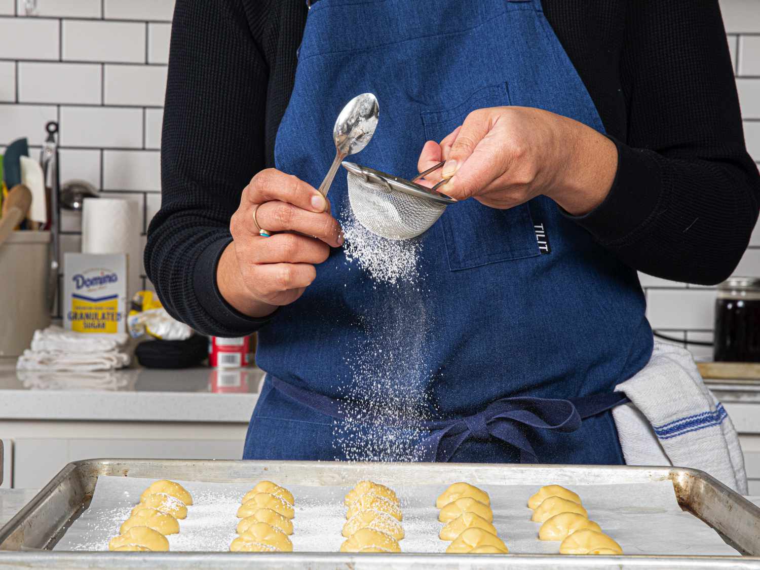 Dusting croquembouche with sugar