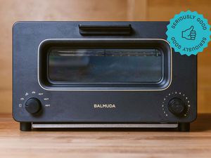 A Balmuda Toaster oven on a wooden countertop