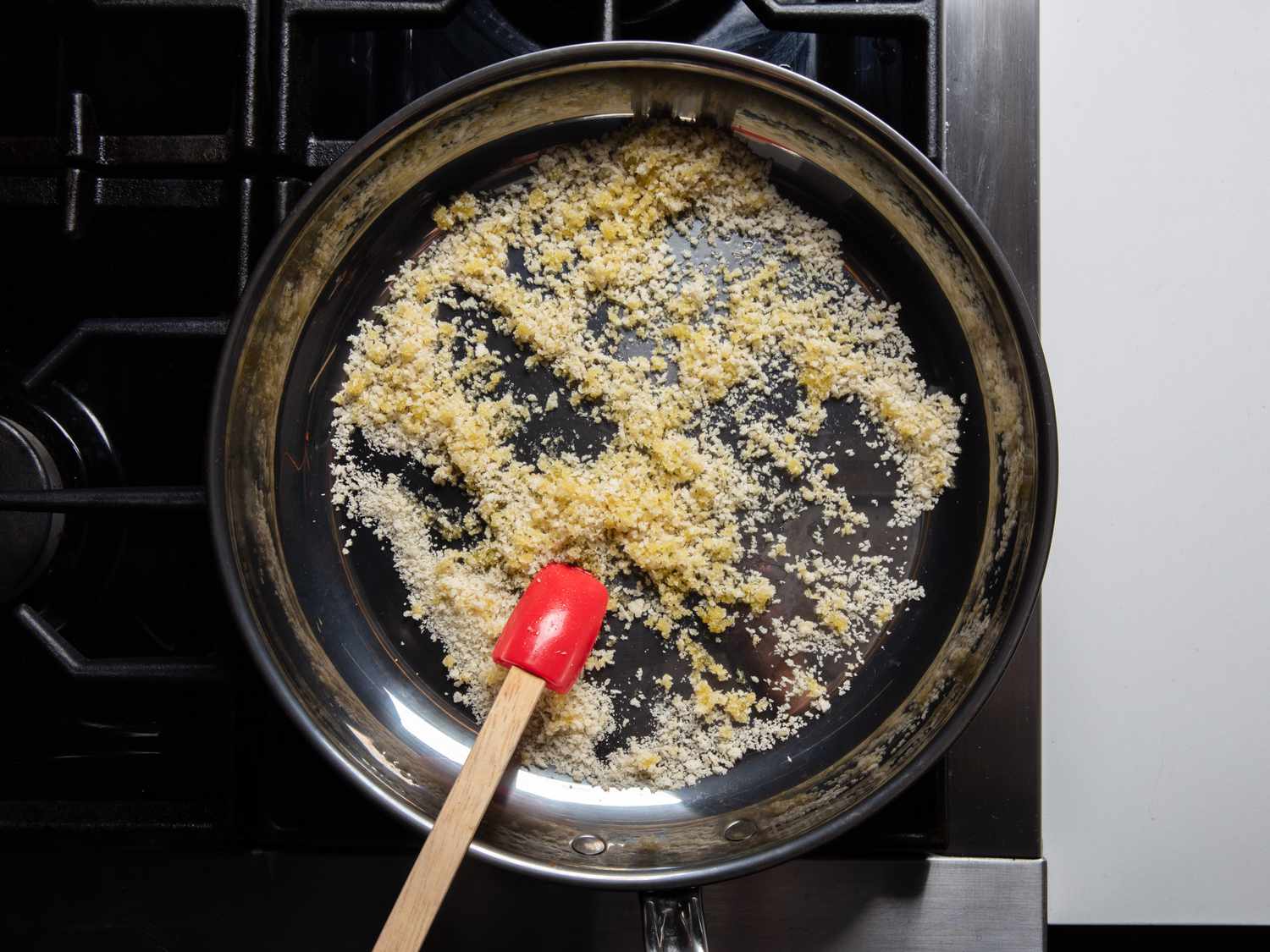 Breadcrumbs in a skillet lightly mixed with olive oil.