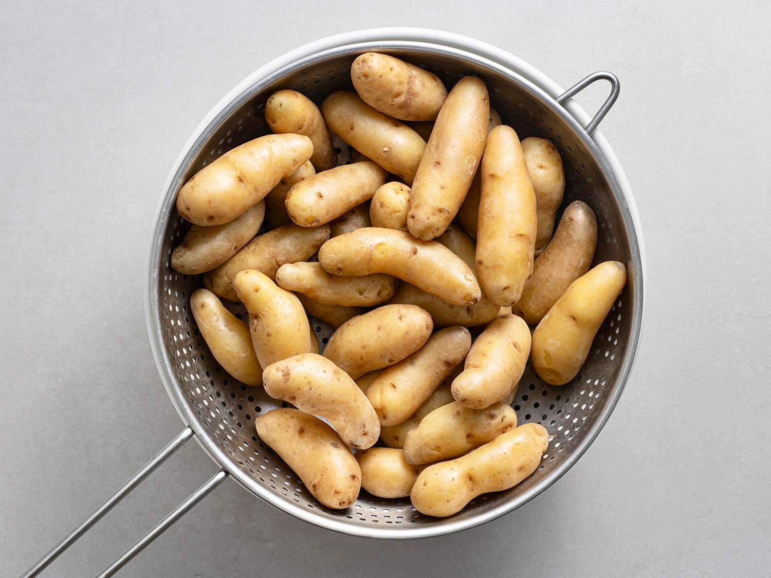 Fignerling potatoes cooling in a strainer