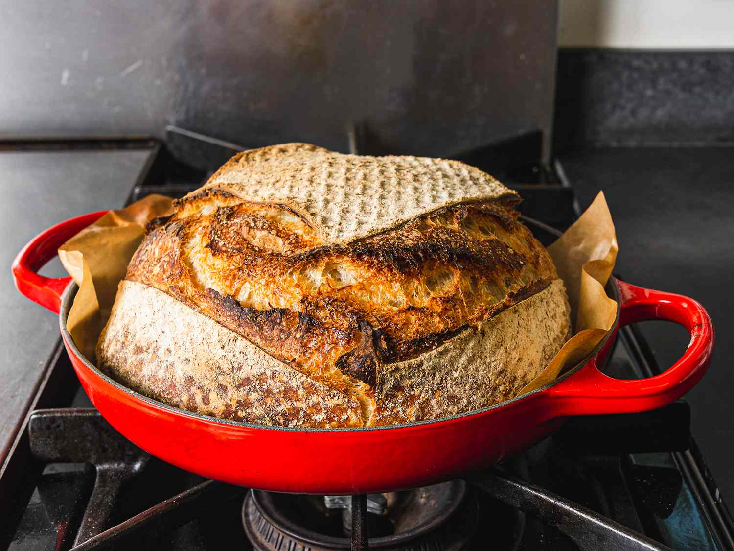 a loaf of finished bread sitting in the Le Creuset bread oven