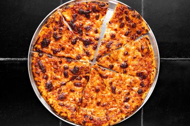 pizza cut into 8 slices on cutting board