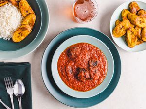 Overhead view of beef stew served with plantains and rice