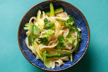 Bowl of potato starch noodles in sesame dressing on a countertop