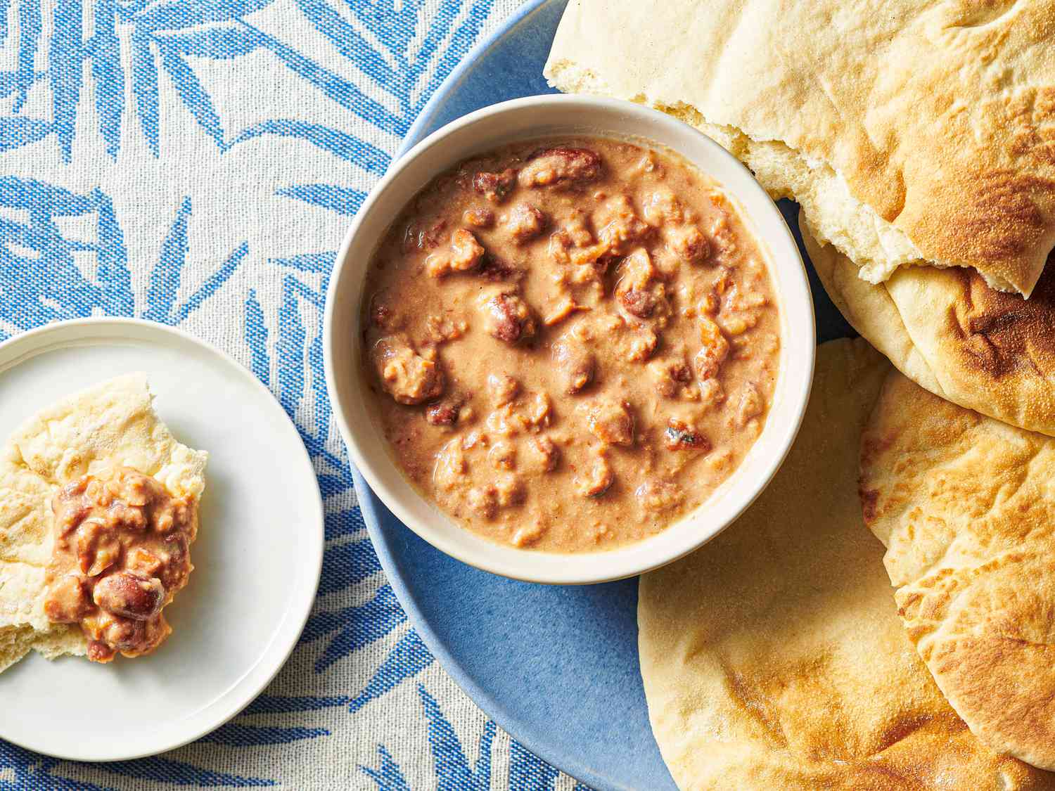 Ful medames served inside a bowl with a side of toasted pita