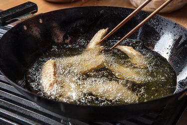 Chicken being deep-fried in a wok