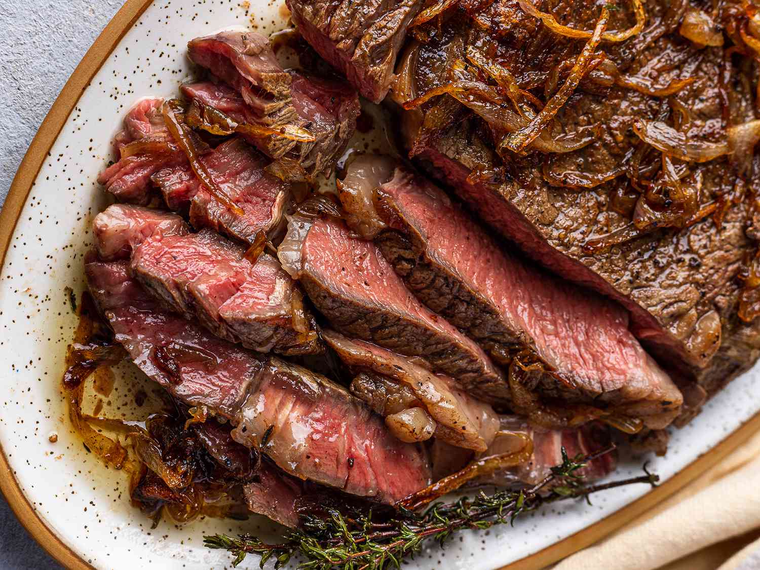 A close up shot of a sliced, pan-seared, butter-basted steak.