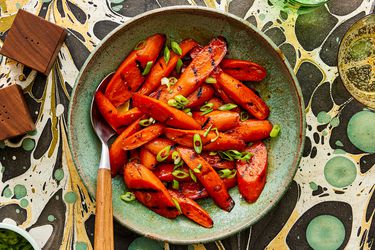 Overhead view of glazed carrots on a funky marble background