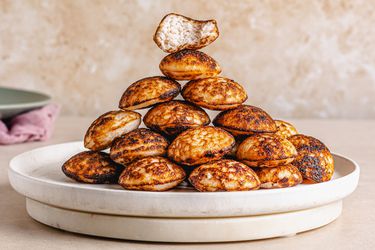 Side view of Nigerian Masa stacked in a pyramid on a plate.