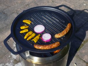 Cooking italian sausage, onions and peppers on the solo stove with the hub and grill grate