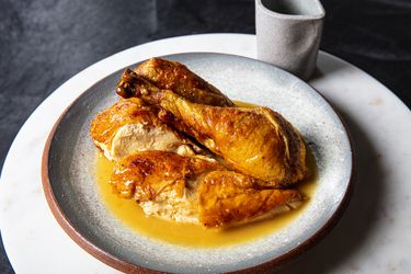 Plated, carved, roasted spatchcocked chicken