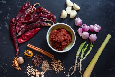 massaman curry paste with ingredients surrounding it