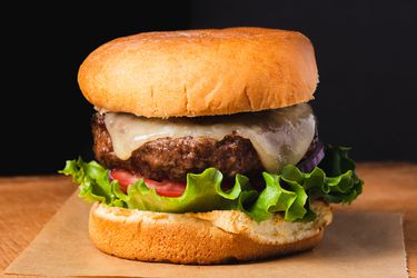 A juicy broiled burger with lettuce, tomato, cheese