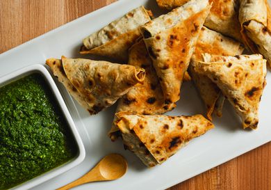 Lavash triangles on a serving platter with dipping sauce.