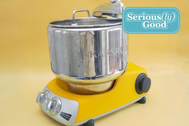 ankarsrum stand mixer on yellow background