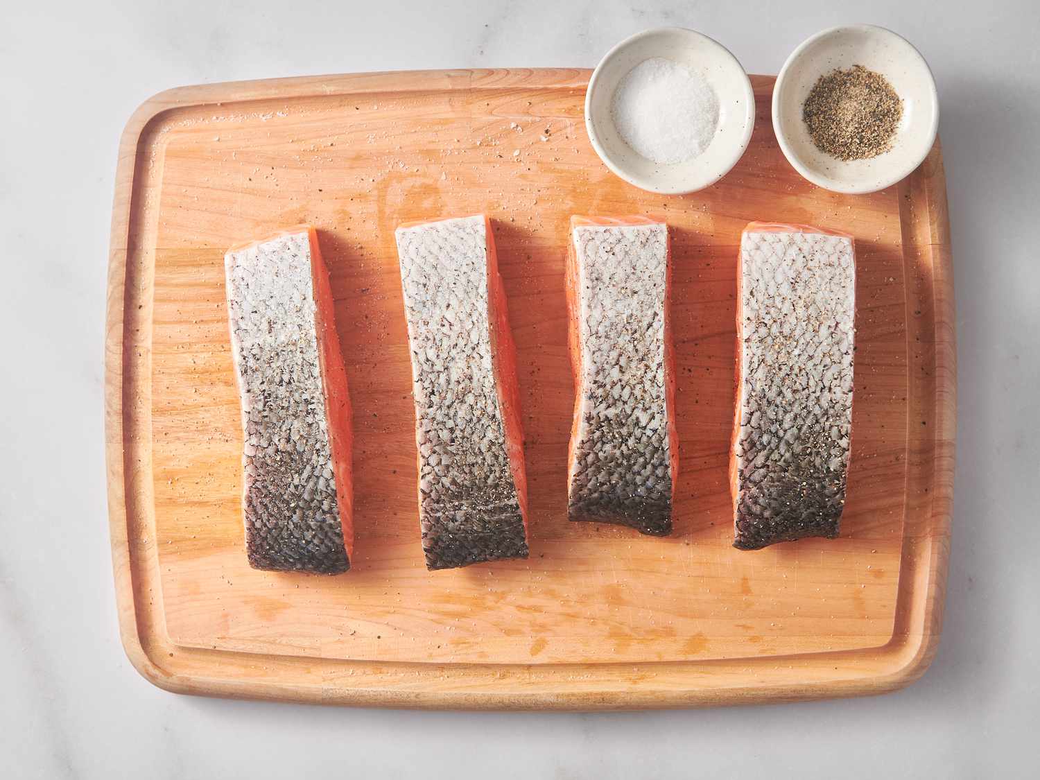 Salmon fillets with surfaces dried thoroughly and seasoned on all sides with salt and pepper