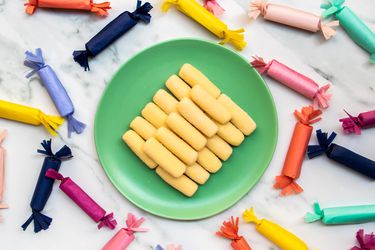 a plate of pastillas de leche surrounded by more candy in wrappers