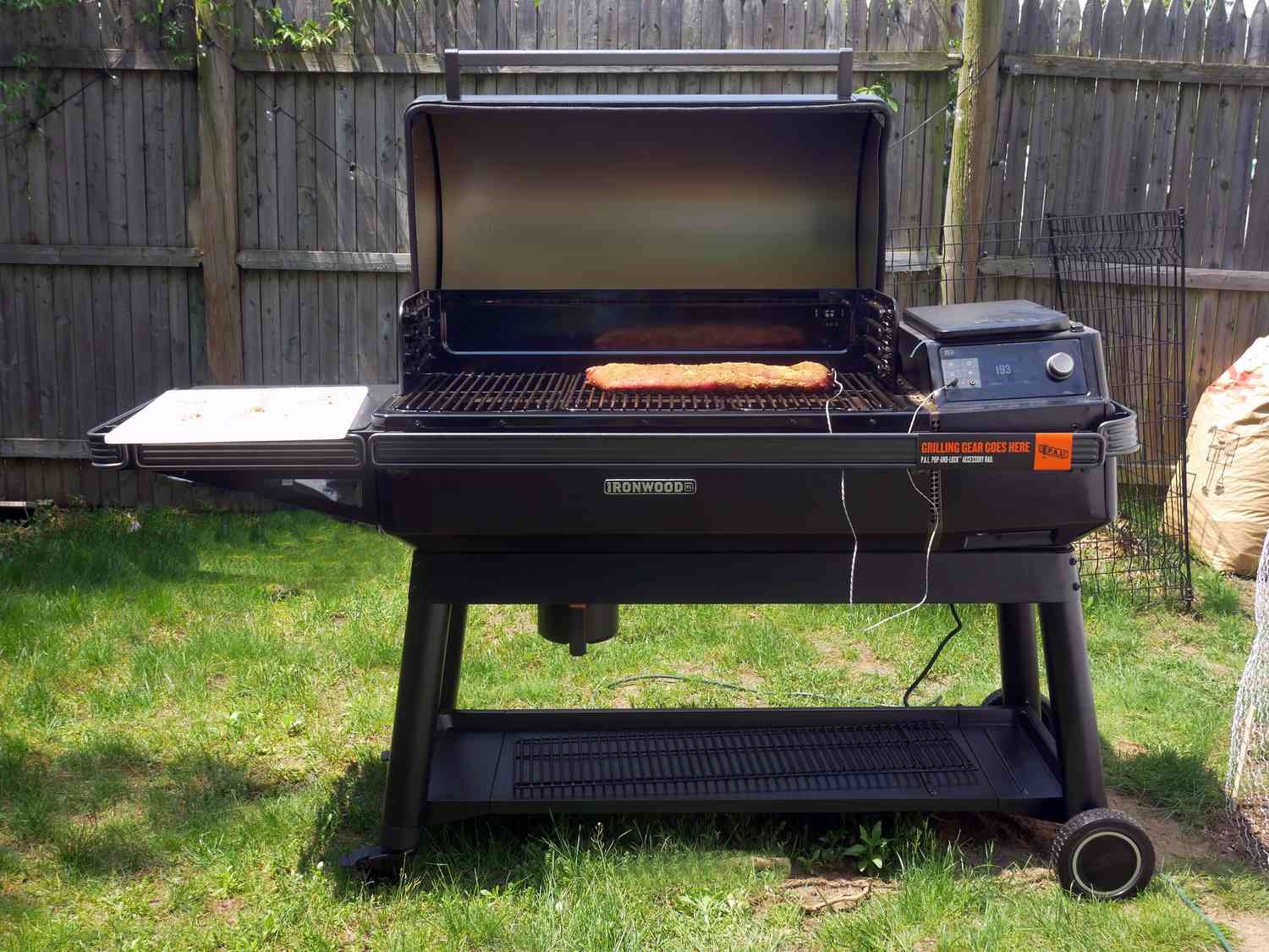 Traeger with lid open and ribs smoking